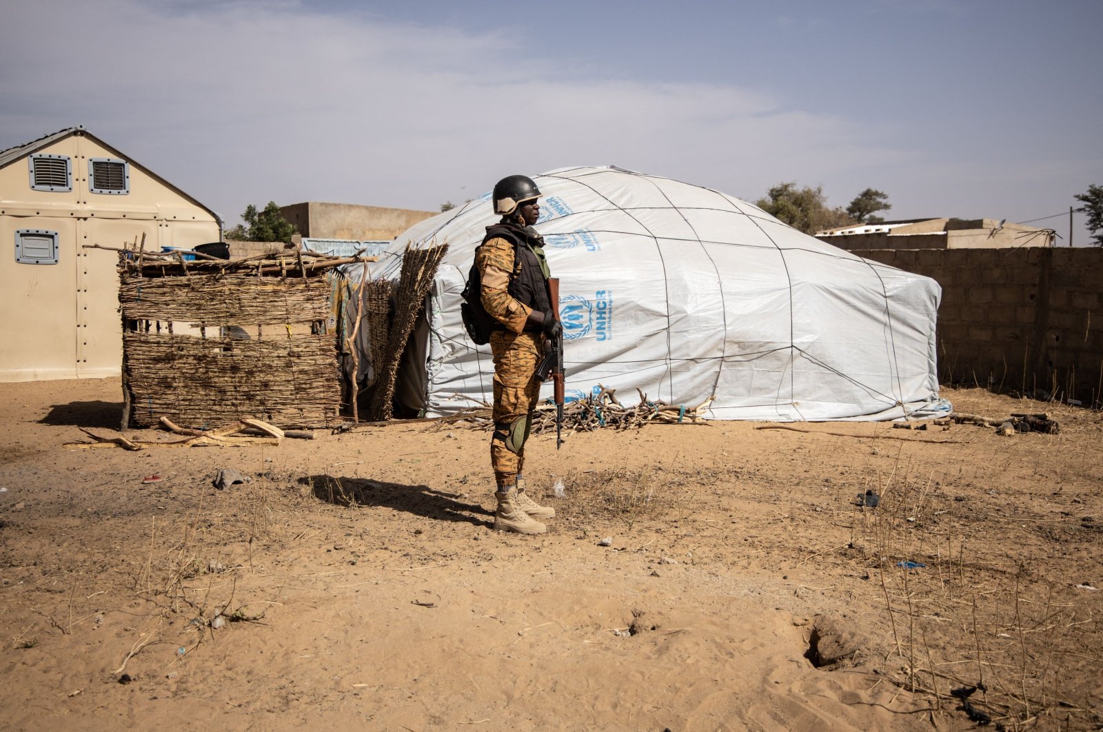In this file photograph taken on February 3, 2020, a Burkina Faso soldier patrols at a camp sheltering Internally Displaced People (IDP) from northern Burkina Faso in Dori. (AFP Photo)