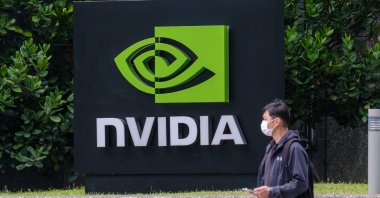 A man is seen passing by the Nvidia logo at the American GPU manufacturer's Taipei office in Taiwan, March 30, 2021. (Reuters Photo)
