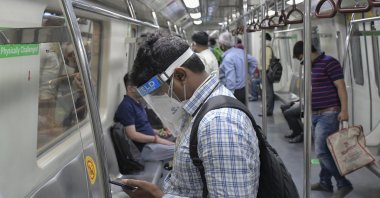 Commuters use the Delhi Metro, which serves the Indian capital and adjoining areas, as it resumed operations at 50% capacity, New Delhi, India, Monday, June 7, 2021. (AP Photo)