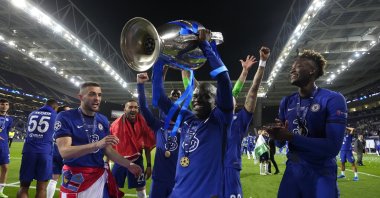 N'Golo Kante of Chelsea celebrates with the Champions League trophy following their team's victory in the UEFA Champions League Final between Manchester City and Chelsea FC at Estadio do Dragao, in Porto, Portugal, May 29, 2021. (Photo by Getty Images)