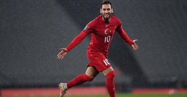 Turkey's Hakan Çalhanoğlu celebrates scoring a goal during the FIFA World Cup Qatar 2022 qualification Group G match against Latvia at the Olympic Stadium, Istanbul, March 30, 2021. (AFP Photo)