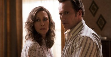 Vera Farmiga (L), and Patrick Wilson stand next to each other, in a scene from "The Conjuring: The Devil Made Me Do It." (Warner Bros. via AP)