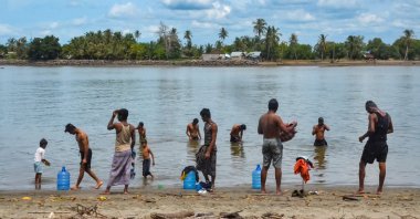 Rohingya refugees bathe at a beach in Pulau Idaman, a small island off the coast of East Aceh in northern Sumatra on June 5, 2021, a day after about 80 Rohingya landed their vessel off the Indonesian coast. (AFP Photo)