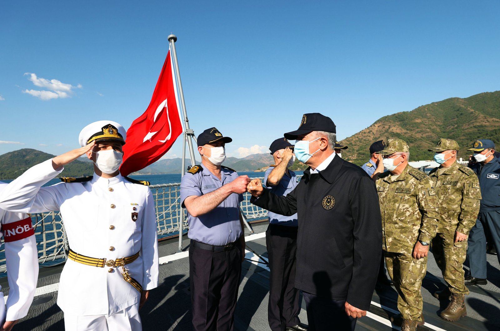 Defense Minister Hulusi Akar (C) stands among a group of international military personnel during the Sea Wolf (Deniz Kurdu) military exercise off Marmaris, Muğla province, Turkey, June 4, 2021. (AA Photo)