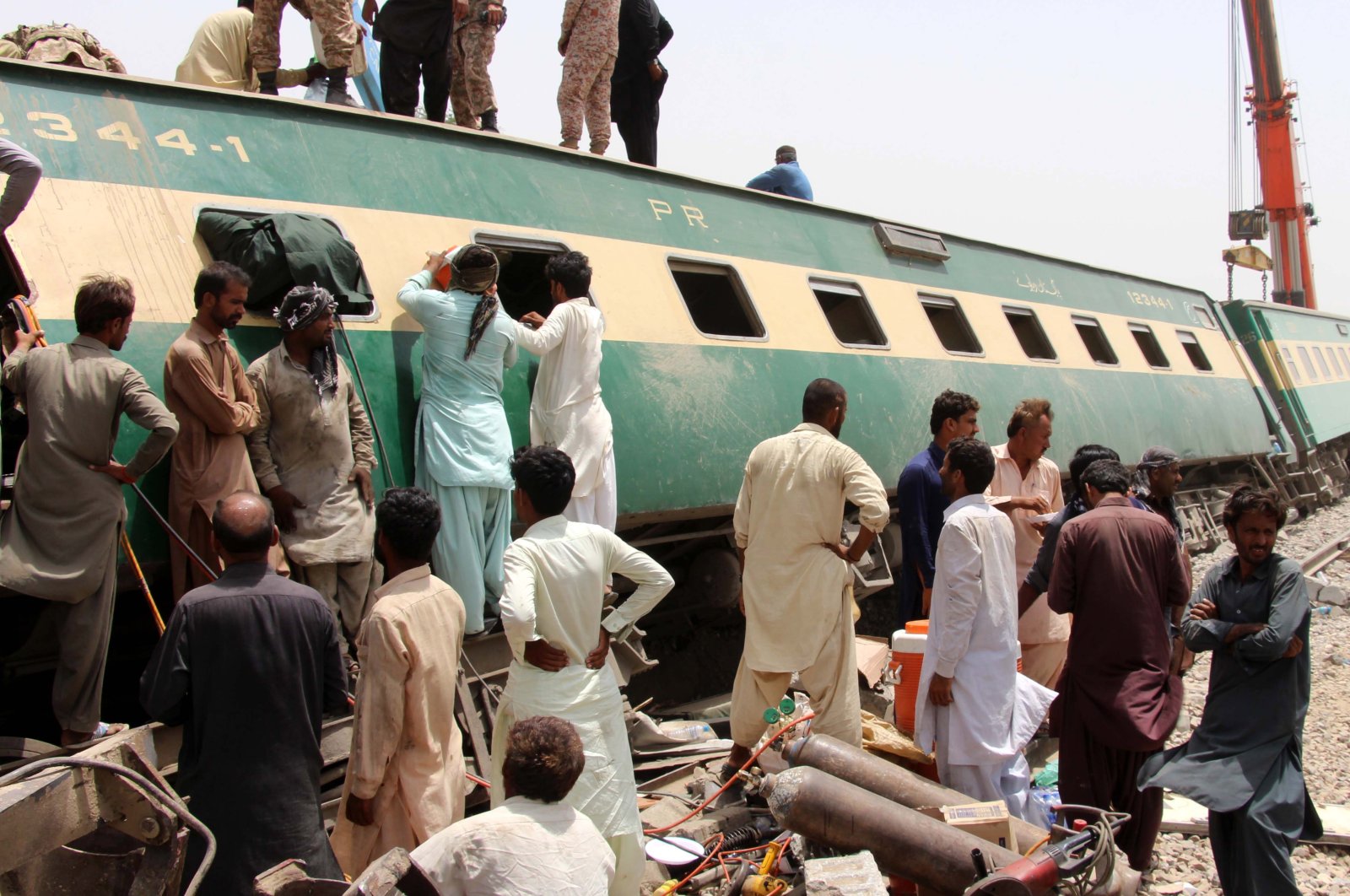 Rescue workers assess the scene following a train accident in Dharki, Sindh province, Pakistan, June 7, 2021. (EPA Photo)