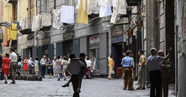 Extras walk along a crowded street on the set of the TV series "My Brilliant Friend" ("L'amica geniale") based on the novels of Elena Ferrante, in Naples, Italy, Jan. 13, 2021. (Getty Images)
