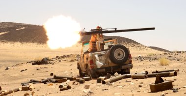 A Yemeni government fighter fires a vehicle-mounted weapon at a frontline position during fighting against Houthi fighters in Marib, Yemen, March 9, 2021. (Reuters Photo)