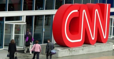 In this file photo, people enter CNN Center, the headquarters for CNN, in downtown Atlanta, Georgia, U.S., Jan. 17, 2001. (AP Photo)