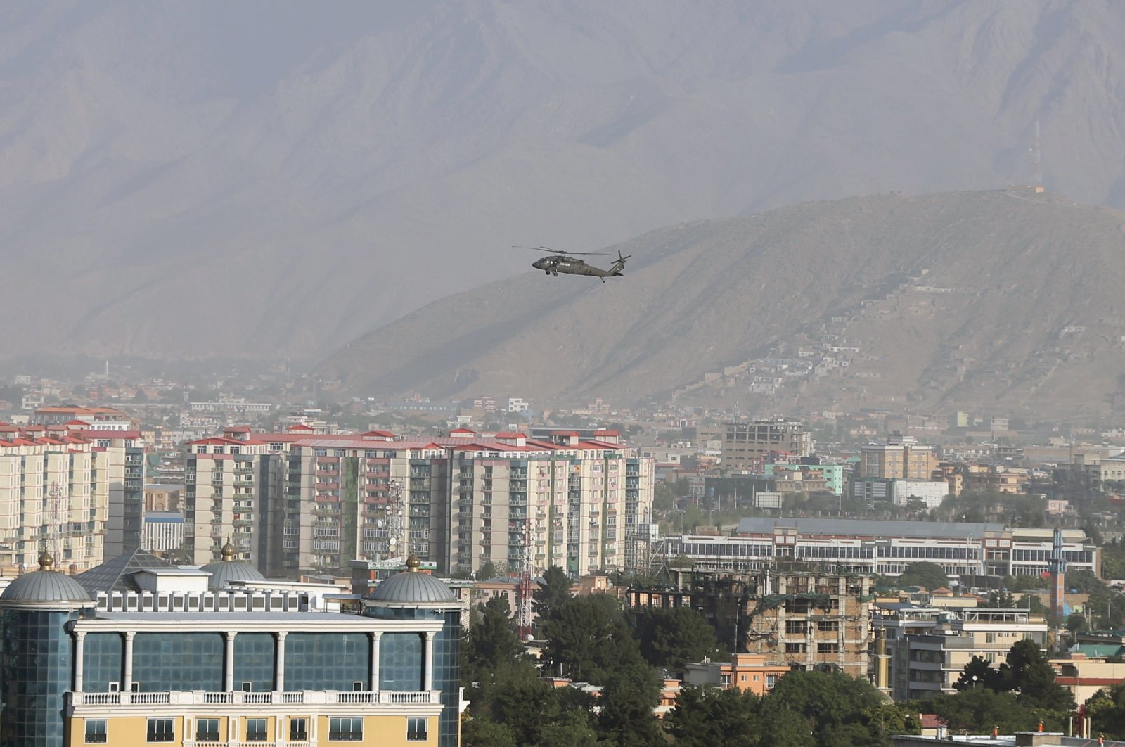 A NATO helicopter flies over the city of Kabul, Afghanistan, June 29, 2020. (REUTERS Photo)