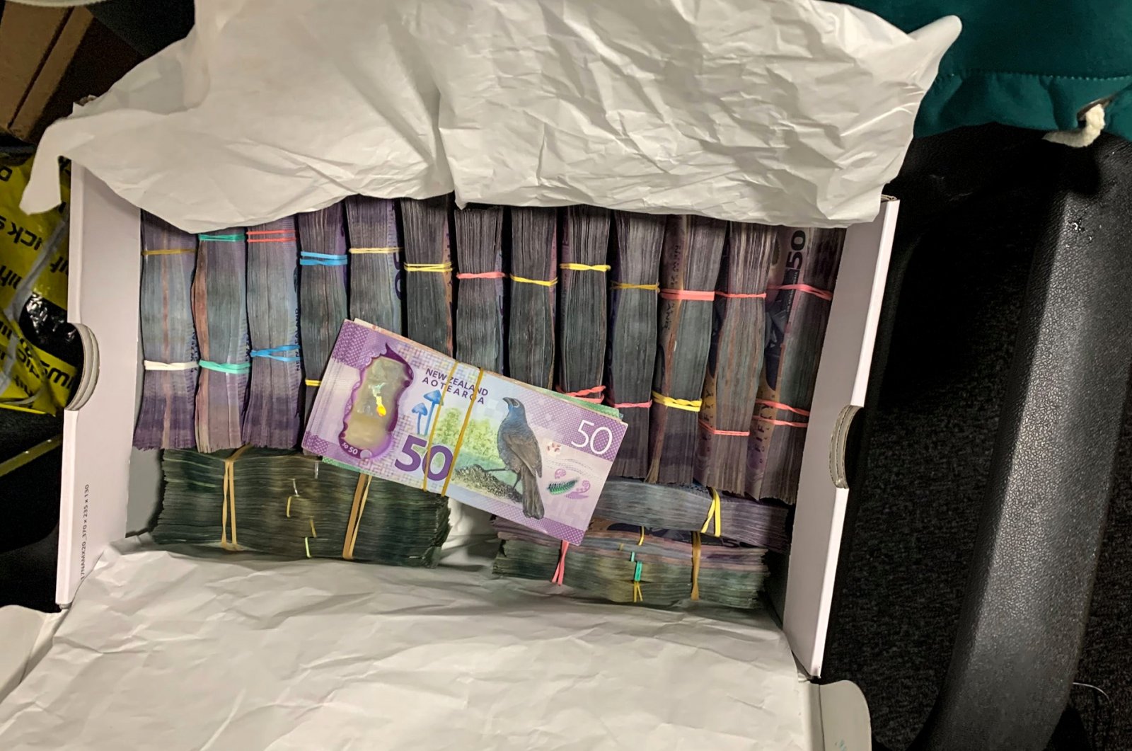 In this undated photo supplied by the New Zealand police, a box containing a large amount of cash is seen after being discovered during a police raid as part of Operation Trojan. (AP Photo)