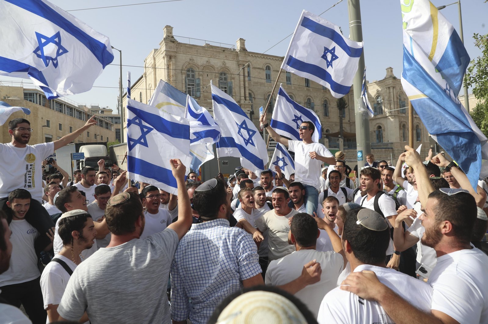 Israelis wave national flags during a Jerusalem Day parade, in Jerusalem, May 10, 2021. (AP File Photo)