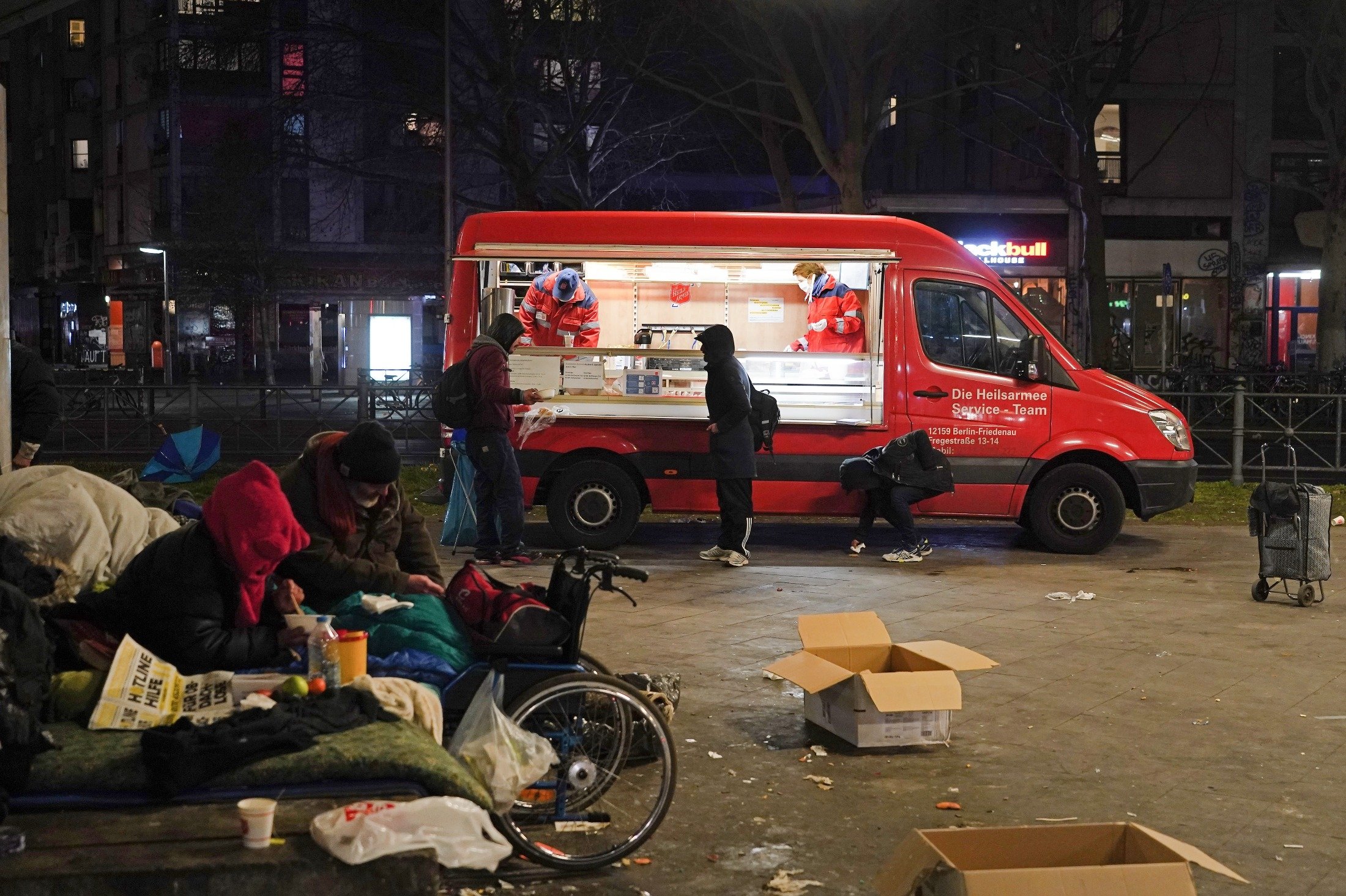 Volunteers of The Salvation Army distribute warm food to homeless people at Kottbuser Tor in the Kreuzberg district of Berlin, Germany, April 2, 2020. (Getty Images)