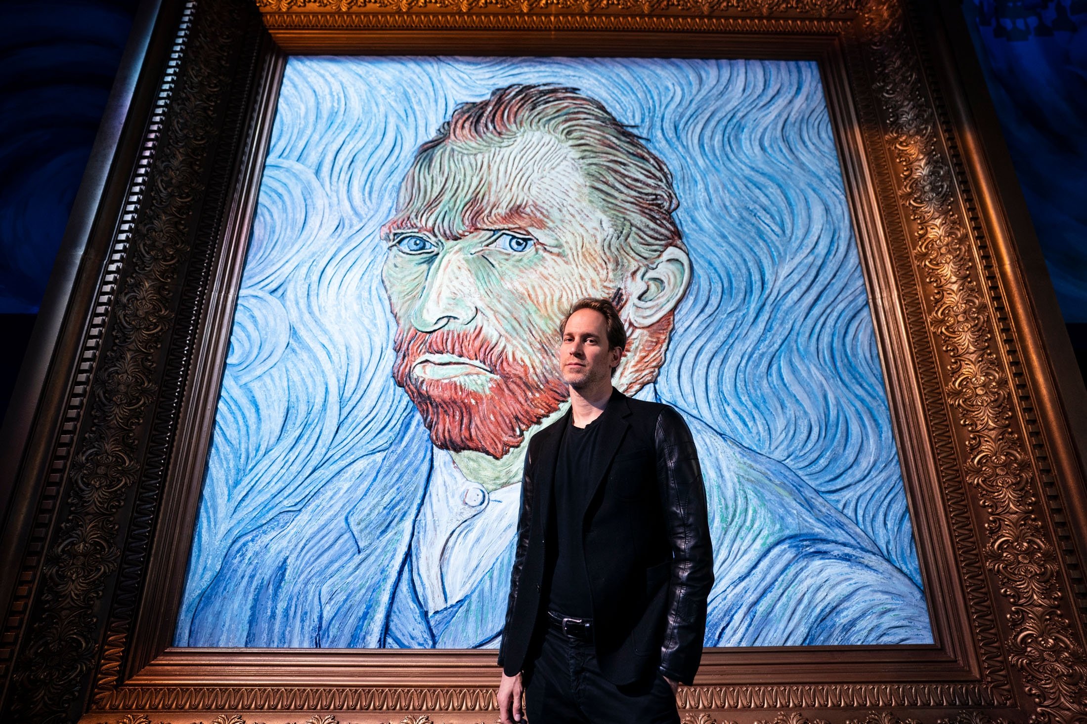 David Korins stands beside a giant replica of celebrated painter Vincent Van Gogh