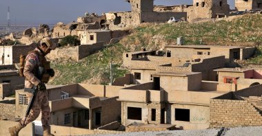An Iraqi soldier walks by ruins in Sinjar, northern Iraq, Dec. 4, 2020. (AP Photo)