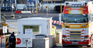 Police officers stand by port security as a lorry drives in at the entrance to the Port of Larne, Northern Ireland, Britain, Jan. 1, 2021. (Reuters Photo)