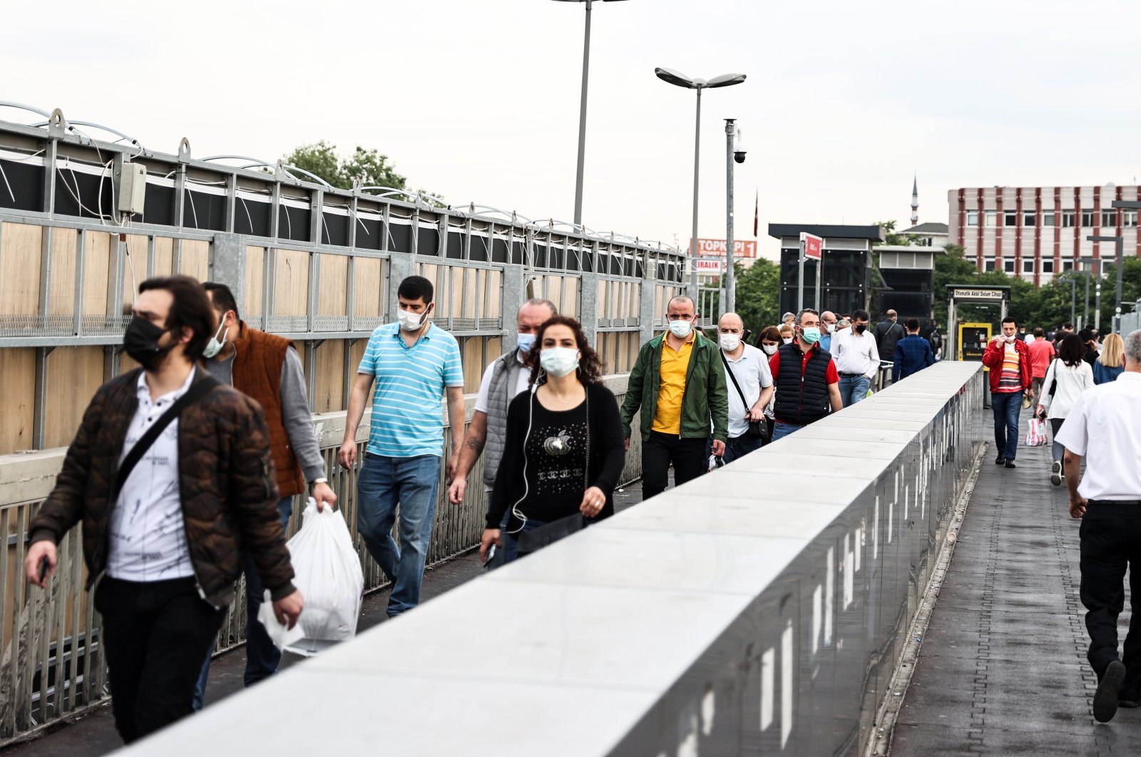 People wearing protective masks walk on an overpass in Istanbul, Turkey, June 7, 2021. (AA PHOTO) 