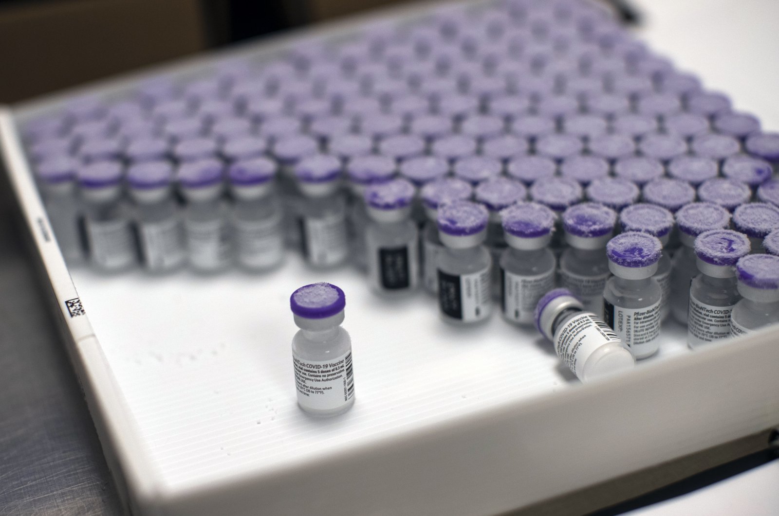 Frozen vials of the Pfizer-BioNTech COVID-19 vaccine are taken out to thaw, at the MontLegia CHC hospital in Liege, Belgium, Jan. 4, 2021. (AP Photo)