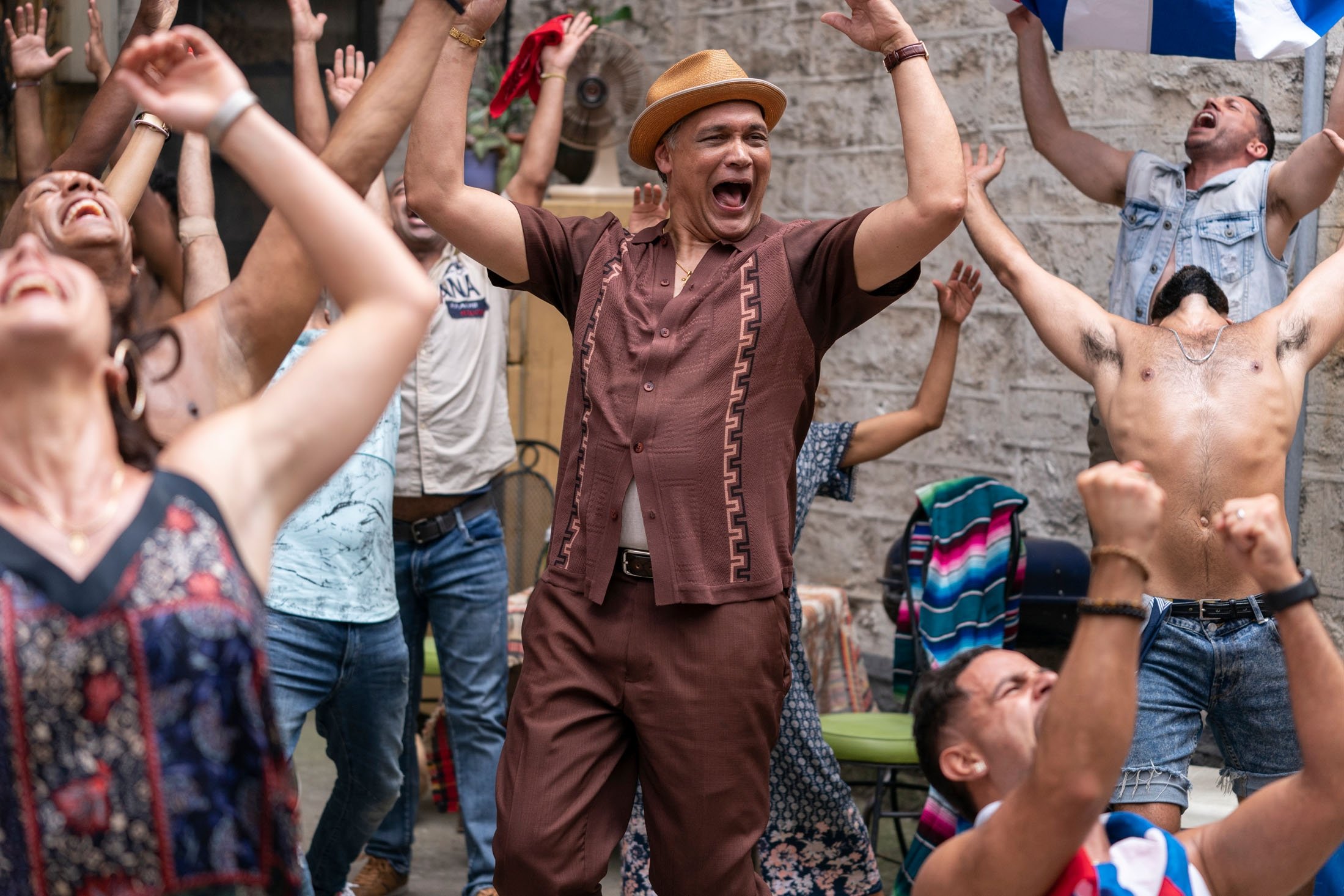 Actor Jimmy Smits (C) celebrates with a crowd in a scene from the musical film "In the Heights." (Warner Bros. via AP)