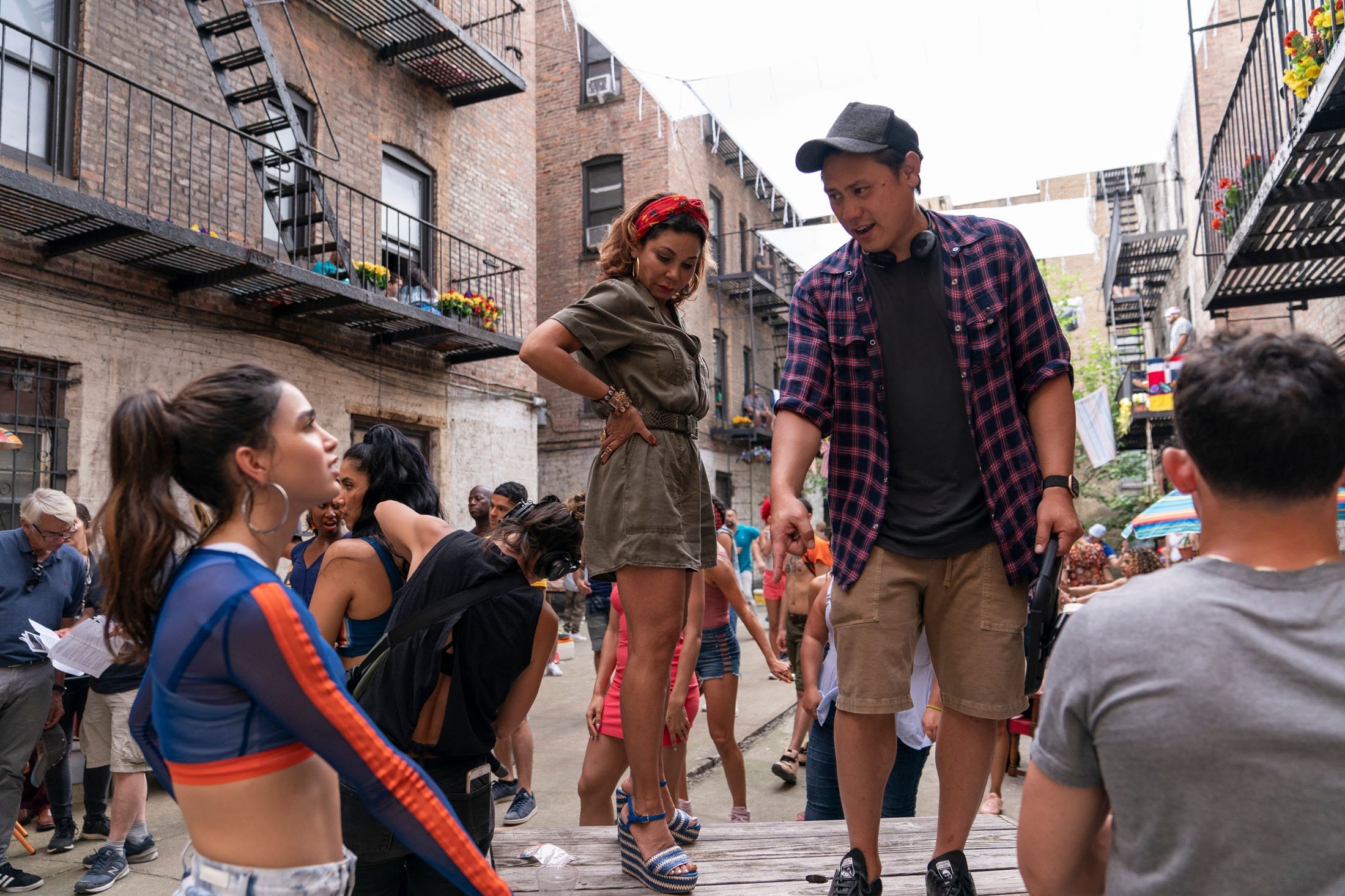 Actress Melissa Barrera (L), Daphne Rubin-Vega (C) and director Jon M. Chu (R) have a conversation during the filming of the musical movie "In the Heights." (Warner Bros. via AP)