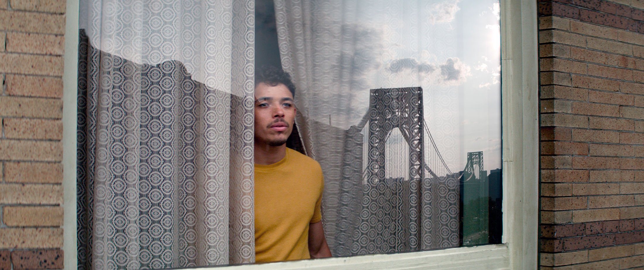Actor Anthony Ramos looks out of the window with New York