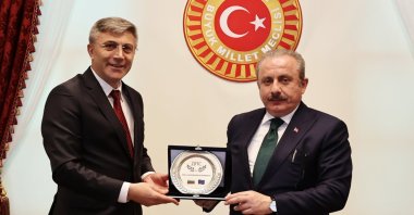 Turkish Parliament Speaker Mustafa Şentop (R) holds a plaque with MRF Party chair Mustafa Karadayı in Ankara, Turkey, June 5, 2021. (AA Photo)