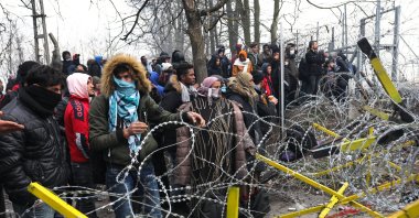 Migrants trying to communicate with Greek soldiers at the Turkish-Greek border, at Pazarkule Border Crossing in Edirne, Turkey, Feb. 29, 2020. (Getty Images)