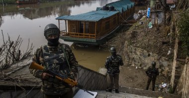 Indian forces stand guard on the bank of the Jehlum river, in Srinagar, Indian-administered Kashmir, March 15, 2021. (Photo by Getty Images)