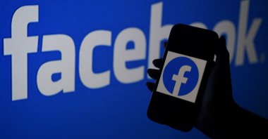 In this file photo illustration, a smart phone screen displays the logo of Facebook on a Facebook website background, in Arlington, Virginia, U.S., April 7, 2021. (AFP Photo)
