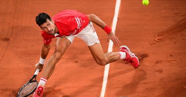 Serbia's Novak Djokovic eyes the ball as he returns it to Italy's Matteo Berrettini during their men's singles French Open quarterfinal match, Paris, France, June 9, 2021. (AFP Photo)