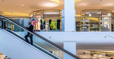 A visitor rides an empty escalator between floors at the Yas Island Mall in Abu Dhabi, United Arab Emirates, May 30, 2016. (Getty Images)