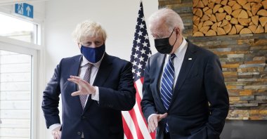 U.S. President Joe Biden and British Prime Minister Boris Johnson look at copies of the Atlantic Charter, during a bilateral meeting ahead of the G-7 summit, in Carbis Bay, England, June 10, 2021. (AP Photo)