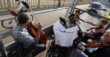 Members of the Budapest Festival Orchestra play music on the back of a truck while driving through downtown Budapest, Hungary, June 9, 2021.  (AP Photo)