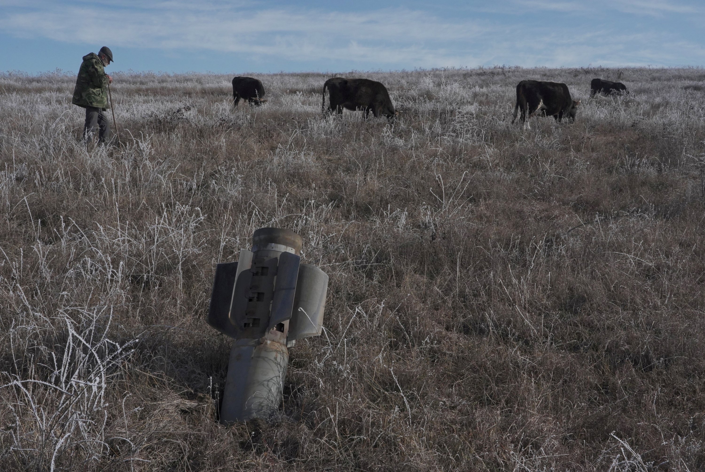 A man shepherds his cows near a rocket case left after a military conflict in the Nagorno-Karabakh region, outside Stepanakert, Azerbaijan, Jan. 6, 2021. (REUTERS)