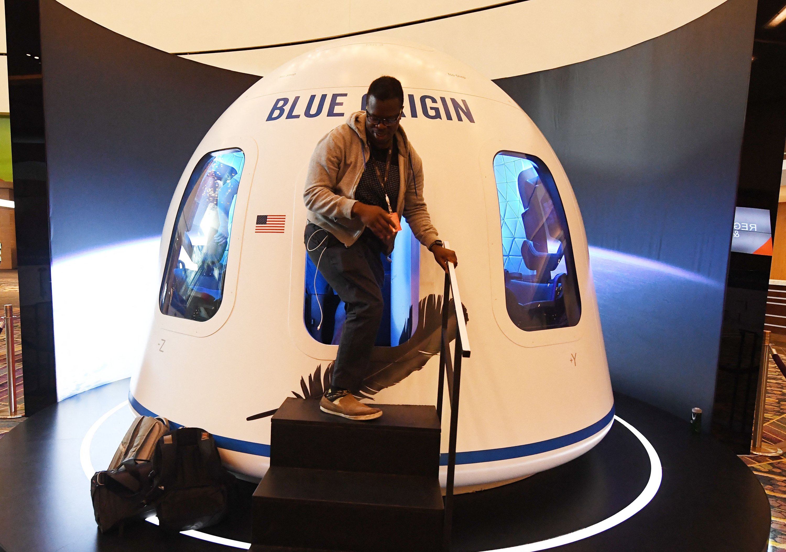 A participant exits the Blue Origin Space Simulator during the Amazon Re:MARS conference on robotics and artificial intelligence at the Aria Hotel in Las Vegas, Nevada, June 05, 2019. (AFP)