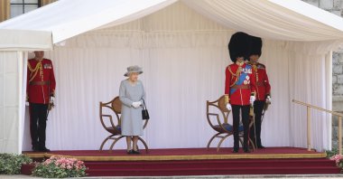 Britain's Queen Elizabeth II and the Duke of Kent watch a military ceremony to mark her official birthday at Windsor Castle, Windsor, England, June 12, 2021. (Pool via AP)
