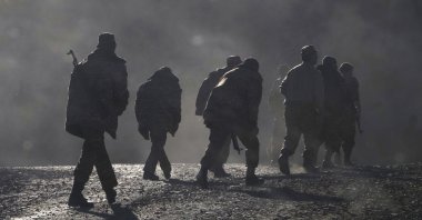 Armenian soldiers walk along the road near the border between Armenia and Nagorno-Karabakh, Azerbaijan, Nov. 8, 2020. (AP Photo)