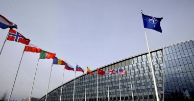 Flags of NATO members flap in the wind outside NATO headquarters in Brussels, Belgium, Feb. 28, 2020. (AP Photo)