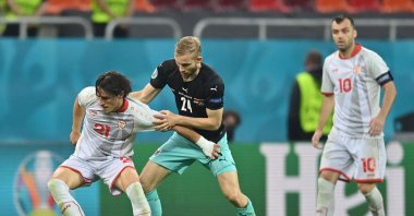North Macedonia's midfielder Eljif Elmas (L) and Austria's midfielder Konrad Laimer vie during the UEFA EURO 2020 Group C football match between Austria and North Macedonia at the National Arena in Bucharest, Romania, June 13, 2021. (AFP Photo)