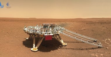 The landing platform with a Chinese national flag and outlines of the mascots for the 2022 Beijing Winter Olympics and Paralympics on Mars is seen from the rover Zhurong, June 11, 2021. (CNSA via AP)