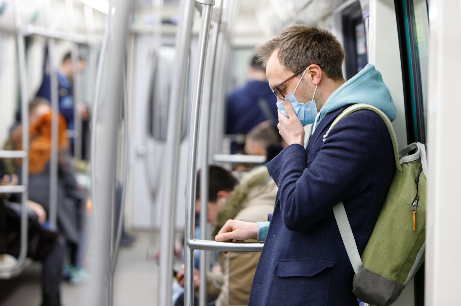 Man wearing protective mask in public transport. (Shutterstock Photo) 