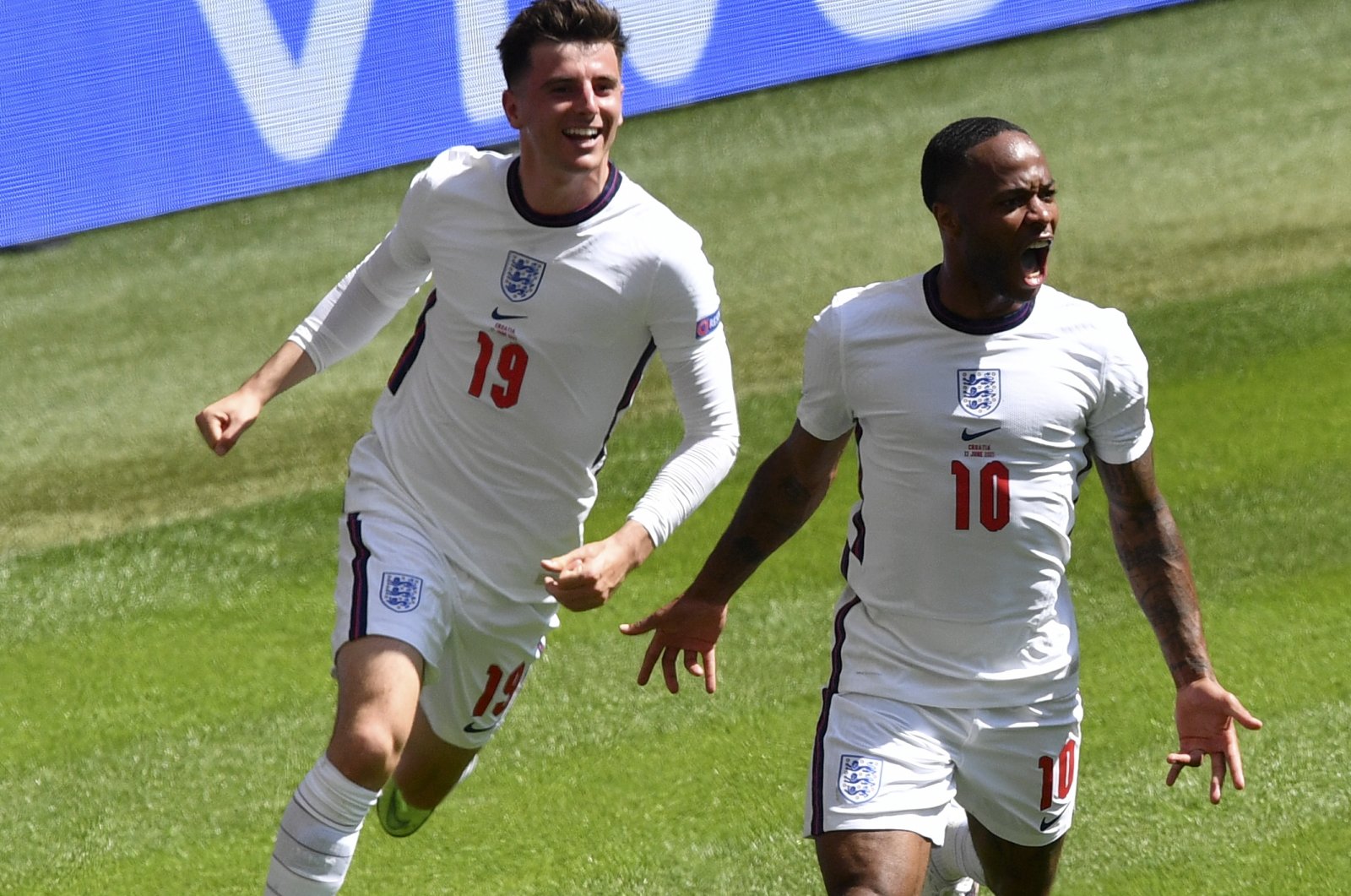 England's Raheem Sterling (R) celebrates with teammate Mason Mount after scoring in the Euro 2020 Group D match against Croatia at the Wembley, London, England, June 13, 2021. (AP Photo)