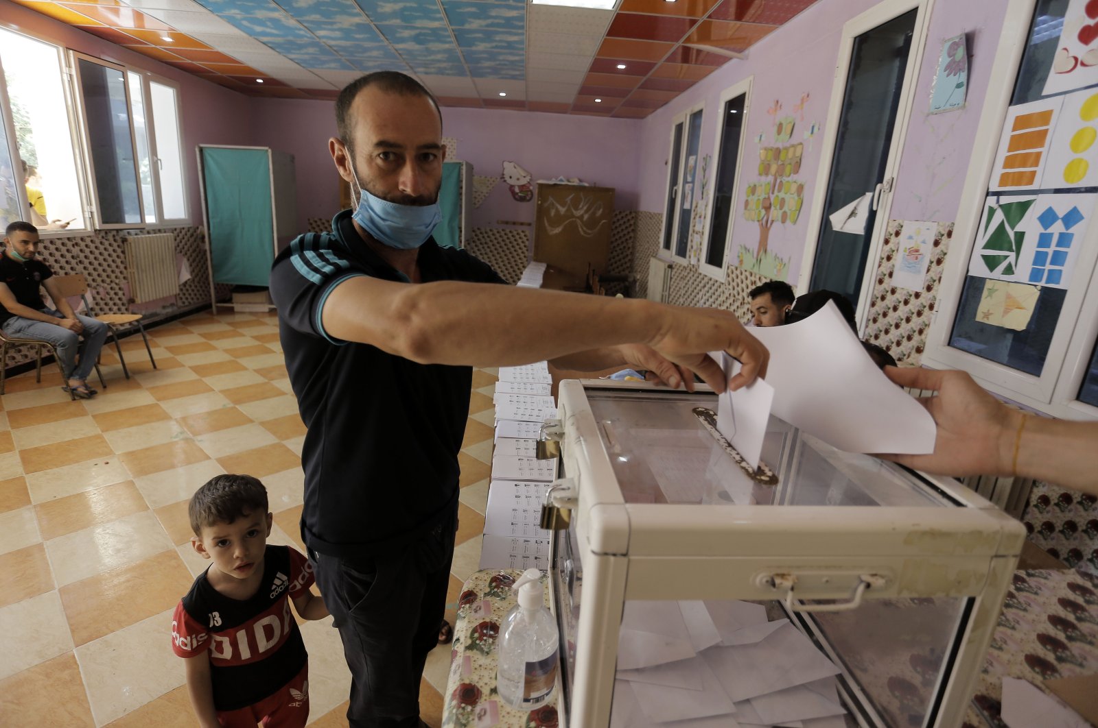 A man casts his vote in a polling station in the country's first legislative elections since the ouster of former President Abdelaziz Bouteflika, in Algiers, Algeria, June 12, 2021. (AP Photo)