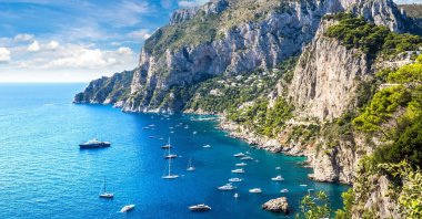 A group of boats float off the shore of the island of Capri, Italy. (Shutterstock Photo)