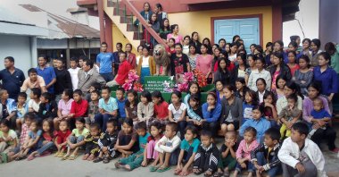 Members of the Chana family pose for a photograph at their home in the village of Baktawng in the Serchhip district, located about 70 kilometers (44 miles) from Mizoram state's capital city Aizawl, northeast India, Oct. 28, 2011. (EFA-EPA Photo)