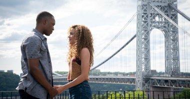 Corey Hawkins (L) and Leslie Grace hold hands in a scene from the musical film "In the Heights." (Warner Bros. via AP)