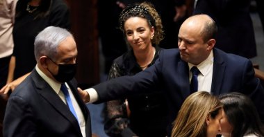 Former Prime Minister Benjamin Netanyahu (L) and Israel Prime Minister Naftali Bennett (R) gesture following the vote on the new coalition at the Knesset, Israel's parliament, in Western Jerusalem, Israel, June 13, 2021. (Reuters Photo)