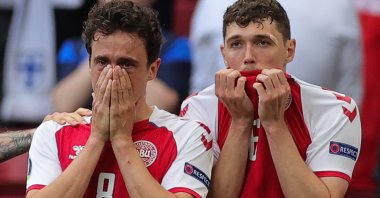 Denmark's midfielder Thomas Delaney and defender Andreas Christensen react as paramedics attend to Denmark's midfielder Christian Eriksen after he collapsed on the pitch during the UEFA EURO 2020 Group B match against Finland at the Parken Stadium, Copenhagen, Denmark, June 12, 2021. (AFP Photo)