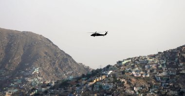 A NATO helicopter flies over the city of Kabul, Afghanistan, June 29. 2020. (Reuters Photo)