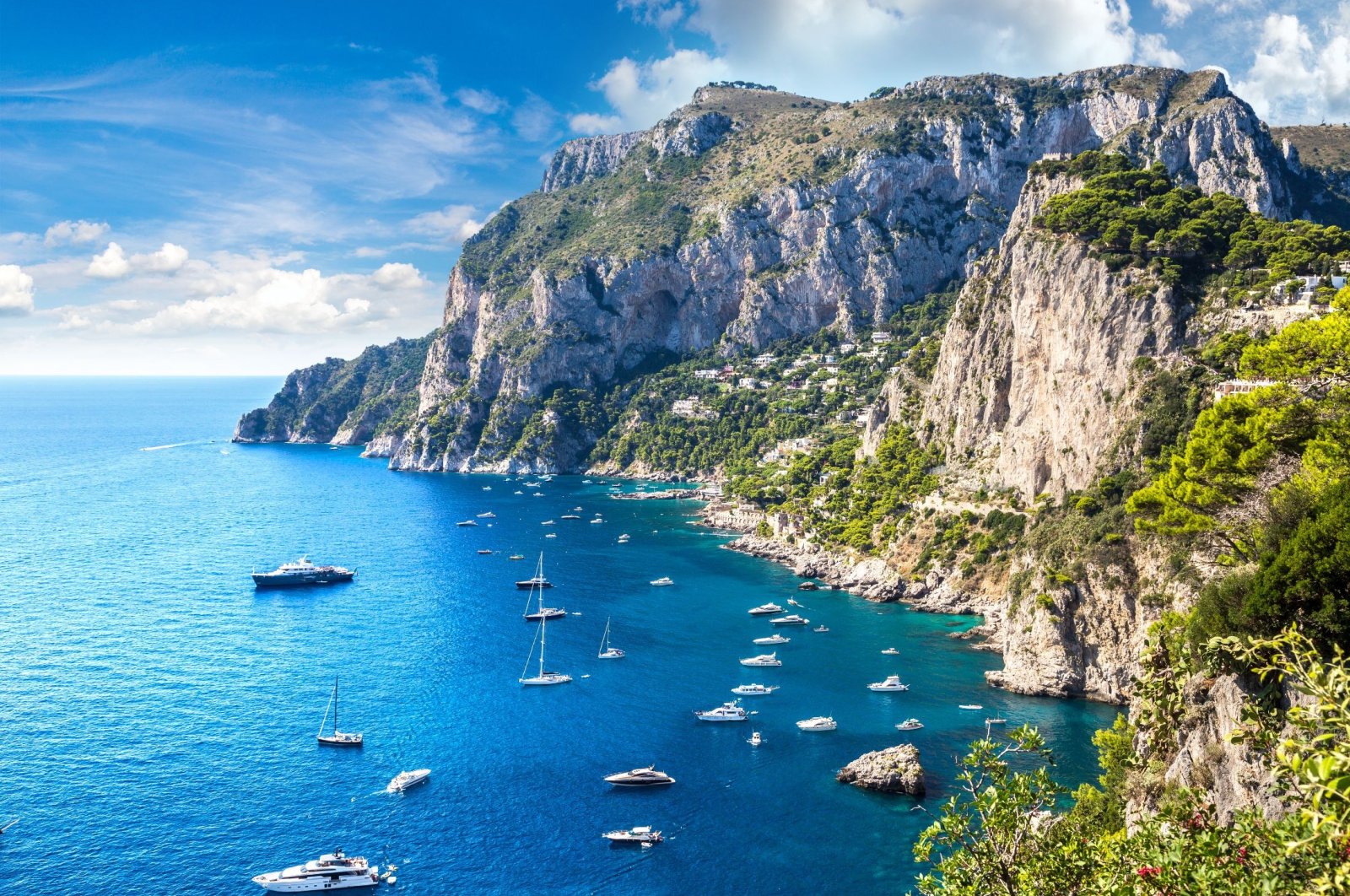 A group of boats float off the shore of the island of Capri, Italy. (Shutterstock Photo)