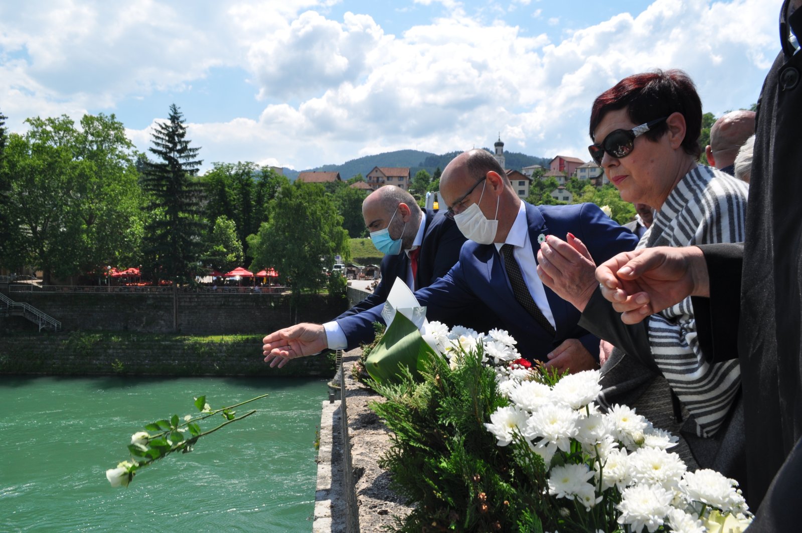 Relatives of the victims of the Visegrad massacre in the Bosnian War in 1992-1995 throw flowers into the Drina river, June 12, 2021. (AA Photo)